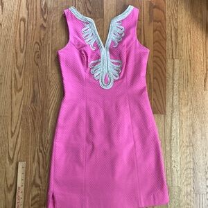 Pink lily Pulitzer dress with gold trim around neck line